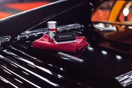 Fireball ceramic coating bottle and applicator on a glossy vehicle